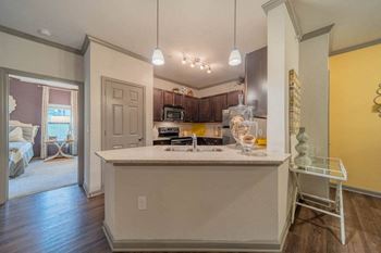 Designer kitchens with custom cabinetry, granite countertops and tile backsplash